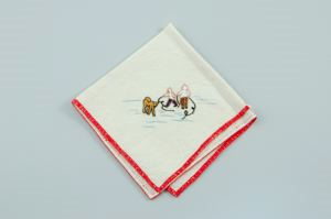 Image of Two figures with a dog, one of a set of 3 embroidered napkins, each with unique scene